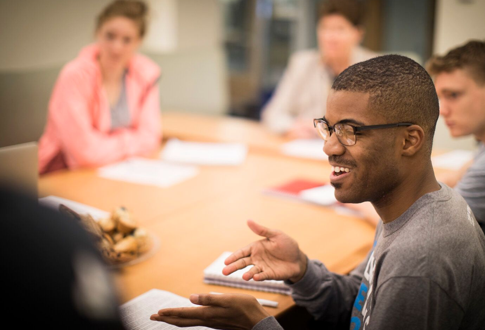 Man smiling in a meeting